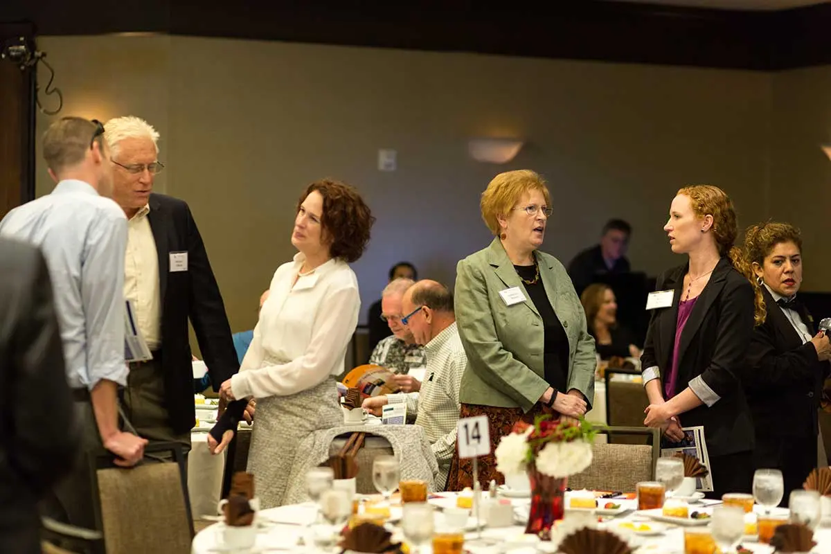 Attendees talking before the event