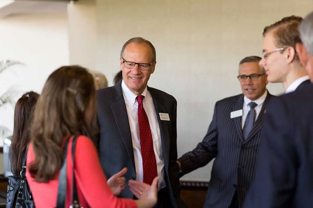 Attendees talking before the event