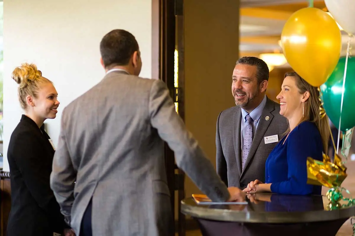 Attendees talking before the event