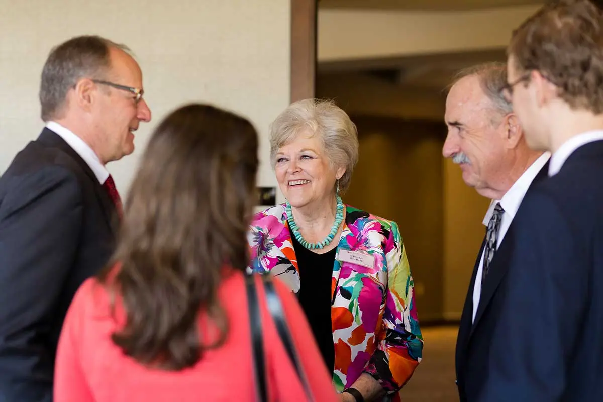 Attendees talking before the event