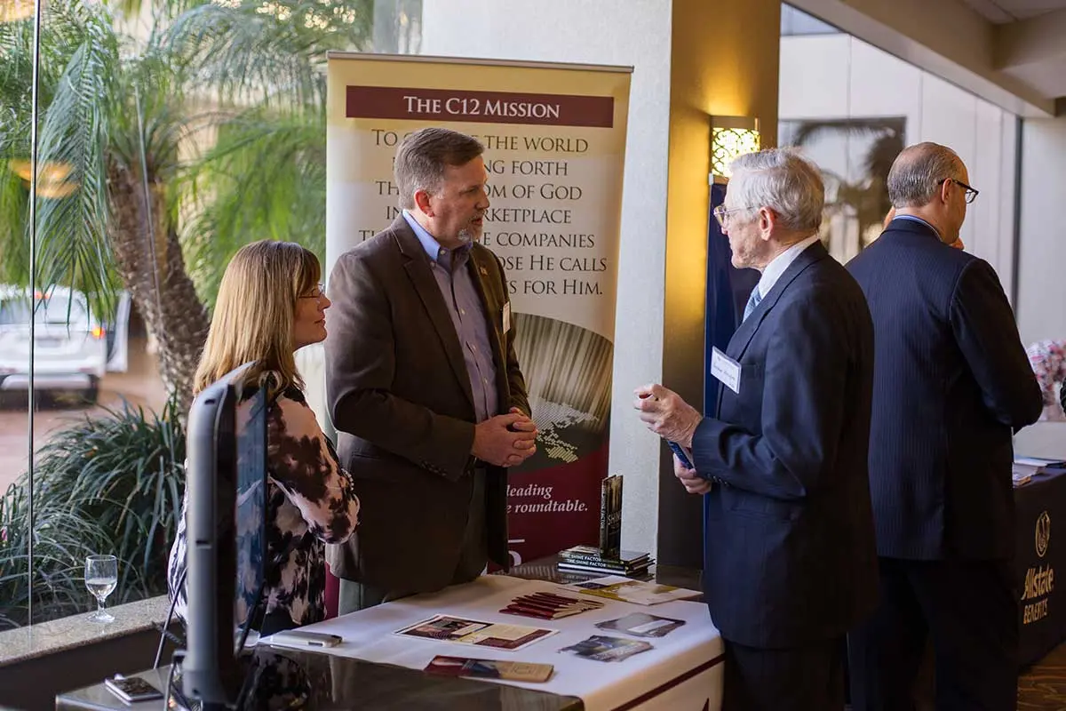 Attendees talking at one of the display tables