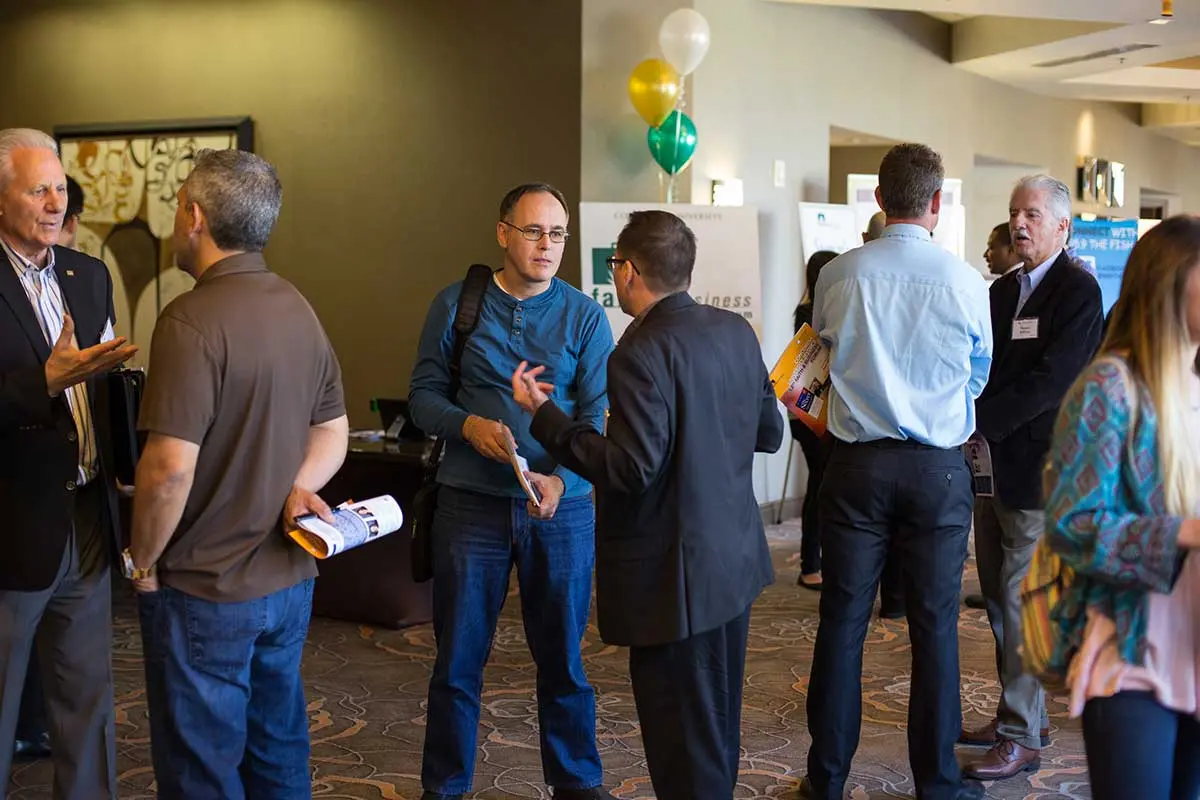 Attendees talking before the event