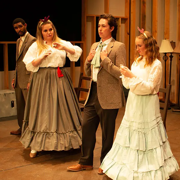 Group of four students performing in a play