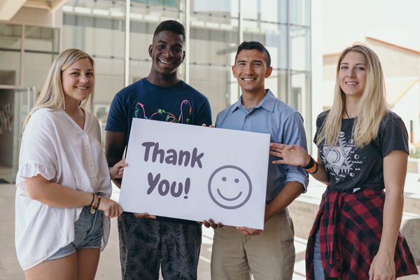 Students holding a poster that says Thank You