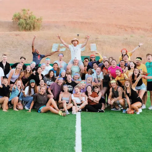 Group of students posing for a photo on the CUI field