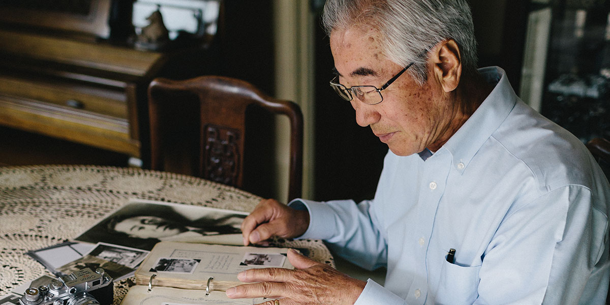 Rev. Dr. Shang Ik Moon looking through a photo book