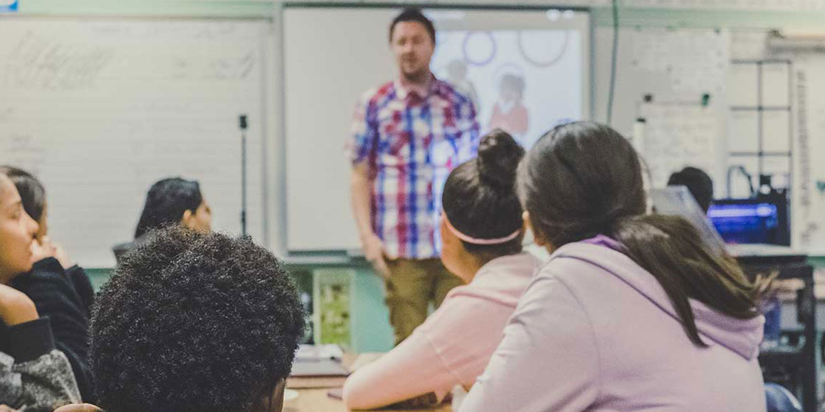 Teacher standing in front of his class