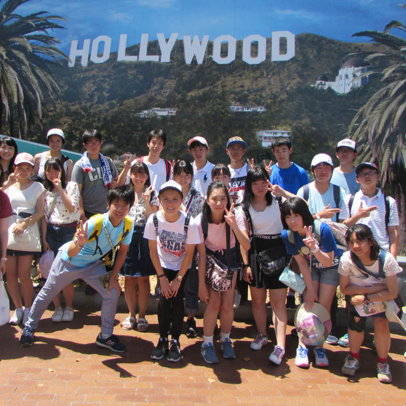 Urawa Exchange students posing in front of a Hollywood sign backdrop