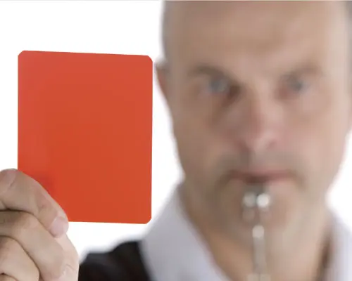 Referee holding a red card