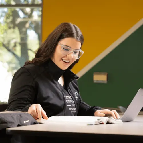 A woman studying for nursing school