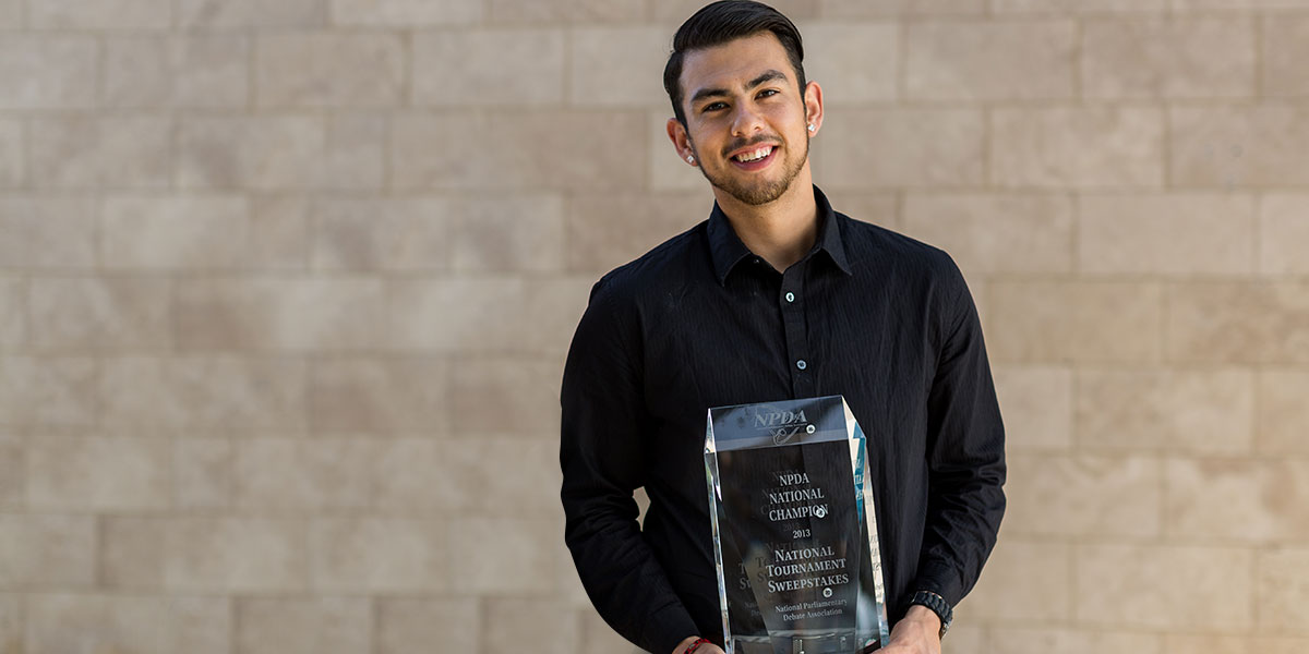 Diego Perez standing with trophy