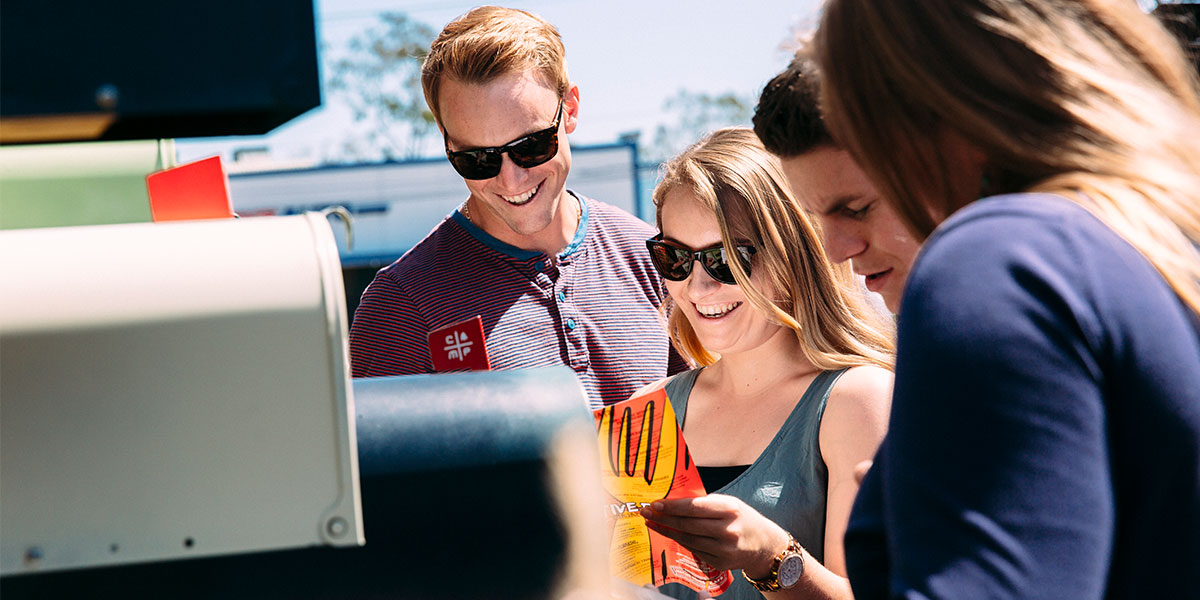 Excited students getting mail from a mailbox