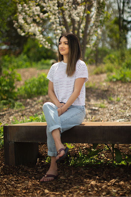 Natalie Cervantes sitting in the Heritage Garden