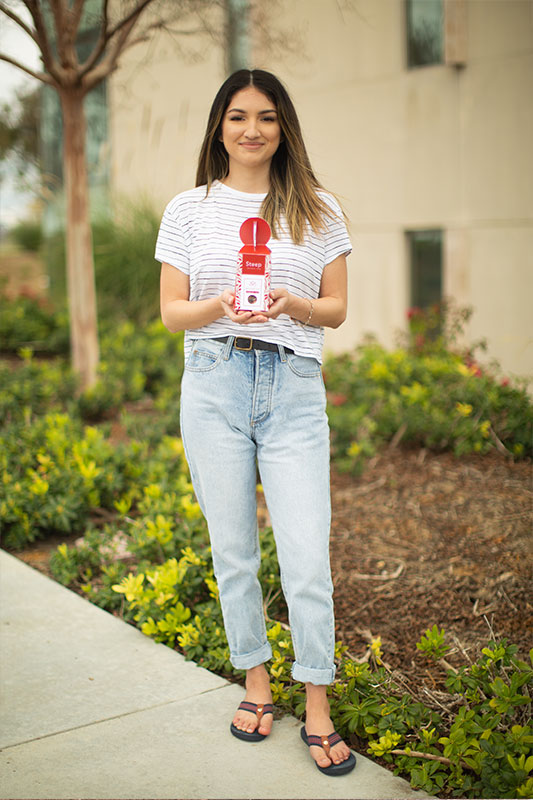 Natalie Cervantes holding one of her packaging projects