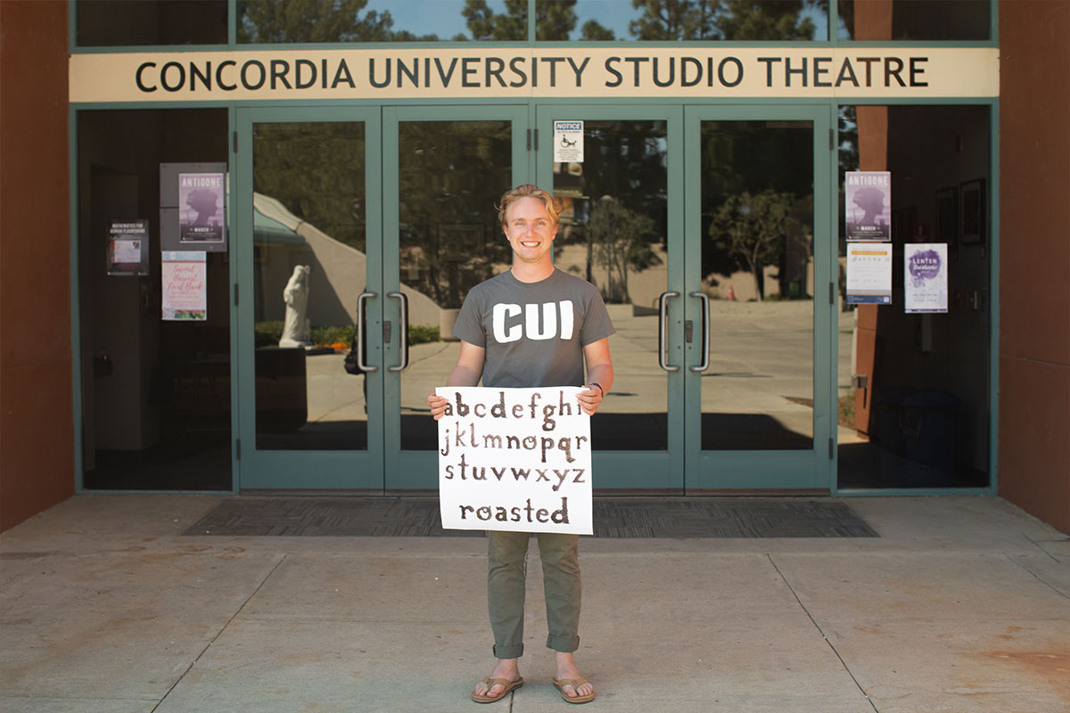 Nathan MacGregor standing with one of his project in front of the theatre