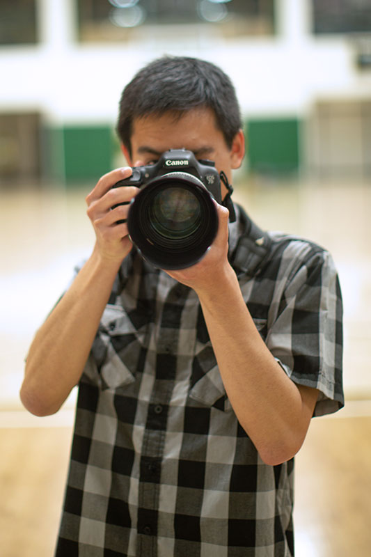 Troy Makalena holding a camera
