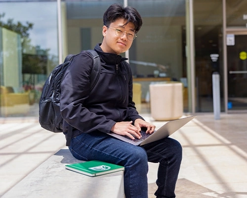 Concordia University Student working on his laptop