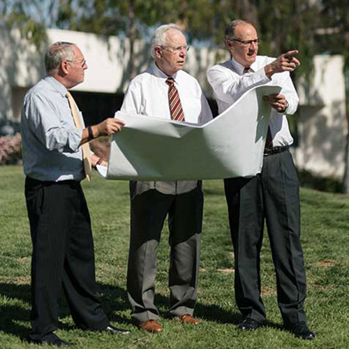 President Krueger pointing to future buildings on campus