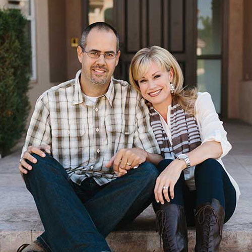 Ryan and Lindsay sitting on the front steps of their house