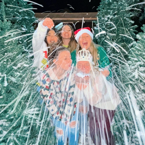 students enjoying the fake snow at Concordia Christmas