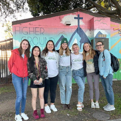 a group of students posing for a group photo at higher ground