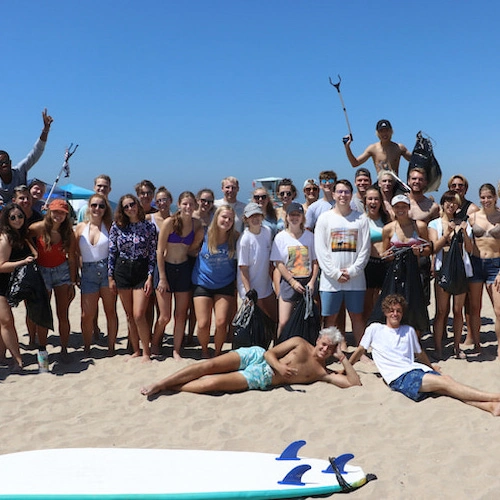 students in a group photo at the beach