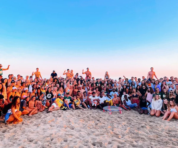 Student group photo at the beach bash