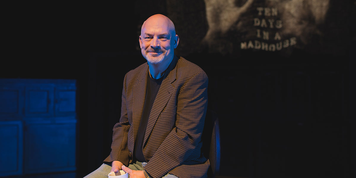 Tony Vezner and the poster for 10 Days in a Madhouse