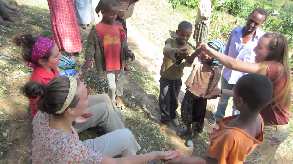 Students playing with children