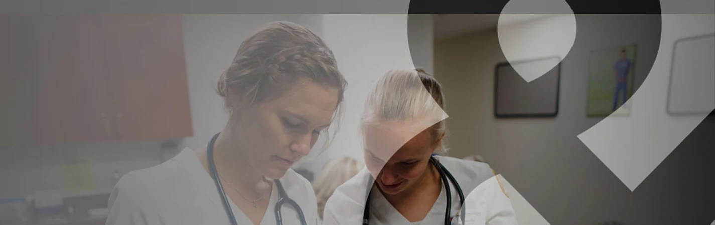 A woman in white scrubs with stethoscope around her neck