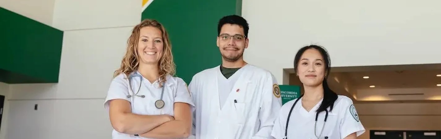 A group of people wearing white scrubs