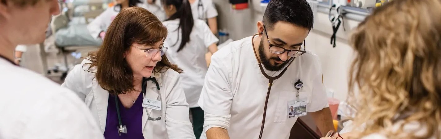 A group of people wearing white scrubs