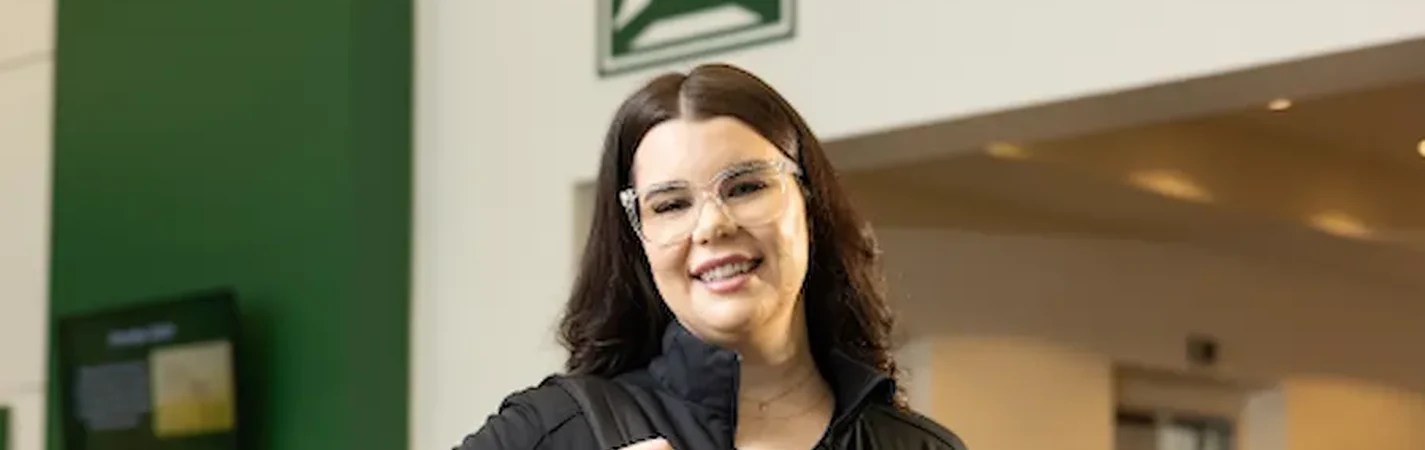 A woman wearing glasses and a black jacket