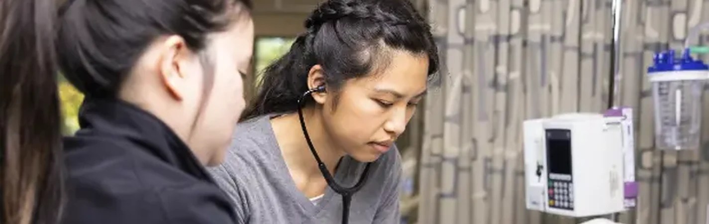 A woman with a stethoscope around her neck