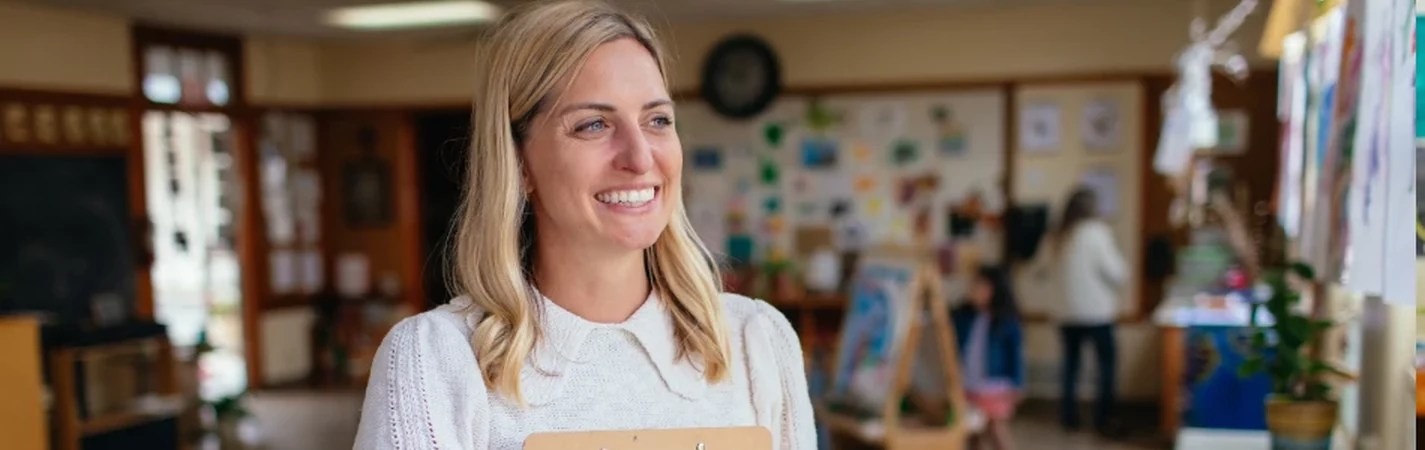 A woman smiling in a classroom