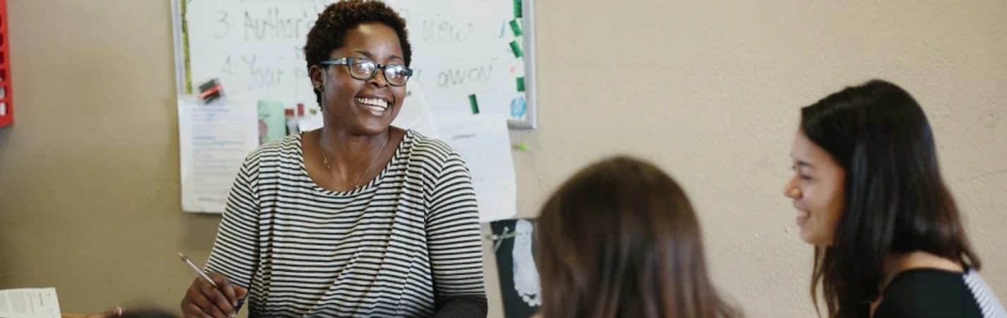 A woman smiling at another woman