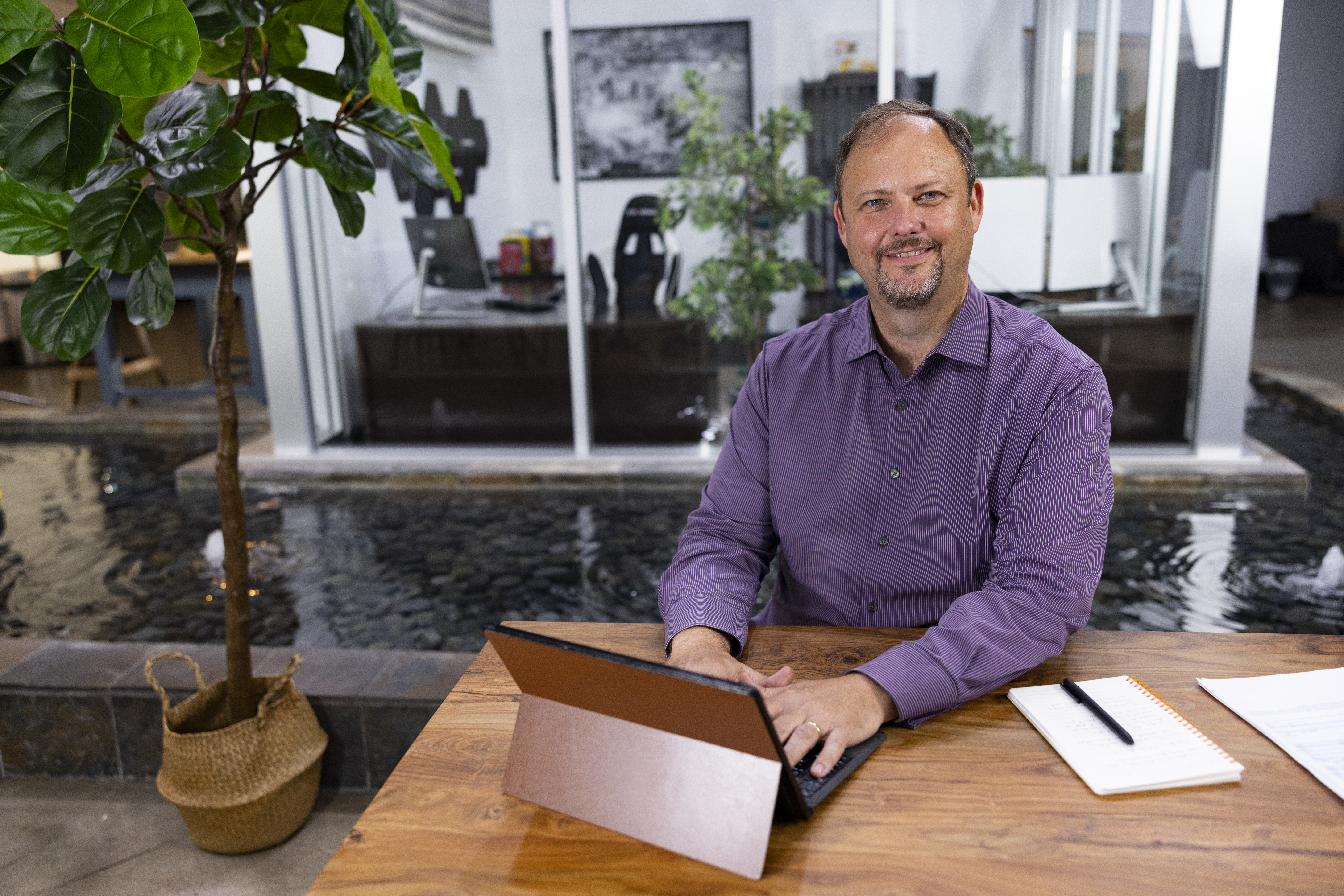 A man sitting at a desk with a laptop