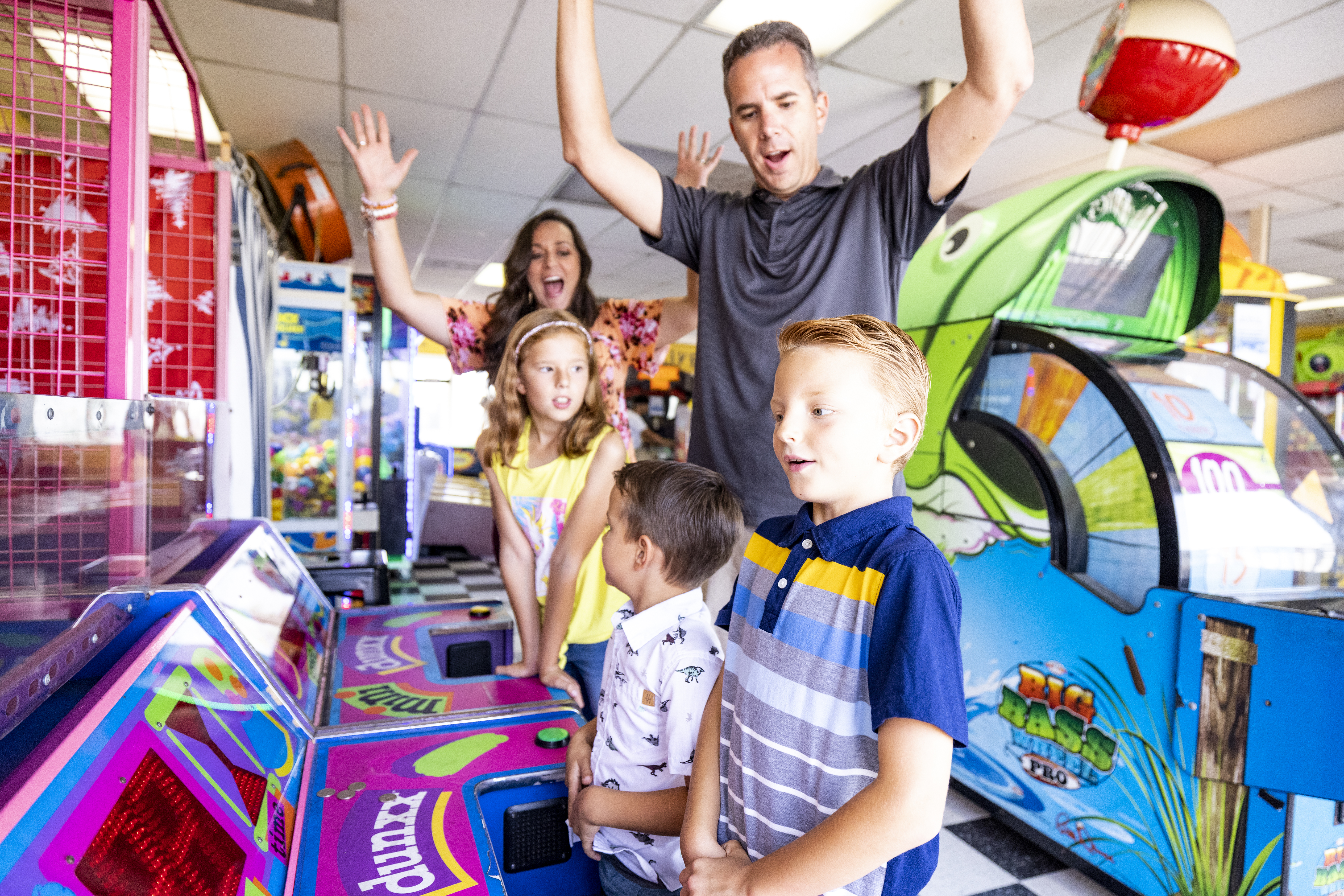 A group of people standing in front of arcade machines