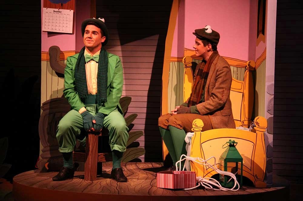 A man in green suit sitting on a chair