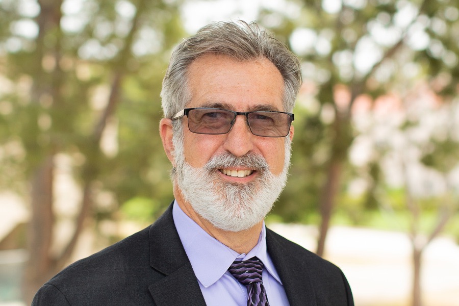 A man with a beard and glasses