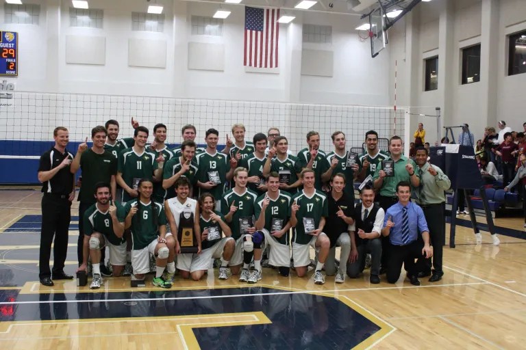 A group of men in sports uniforms posing for a photo