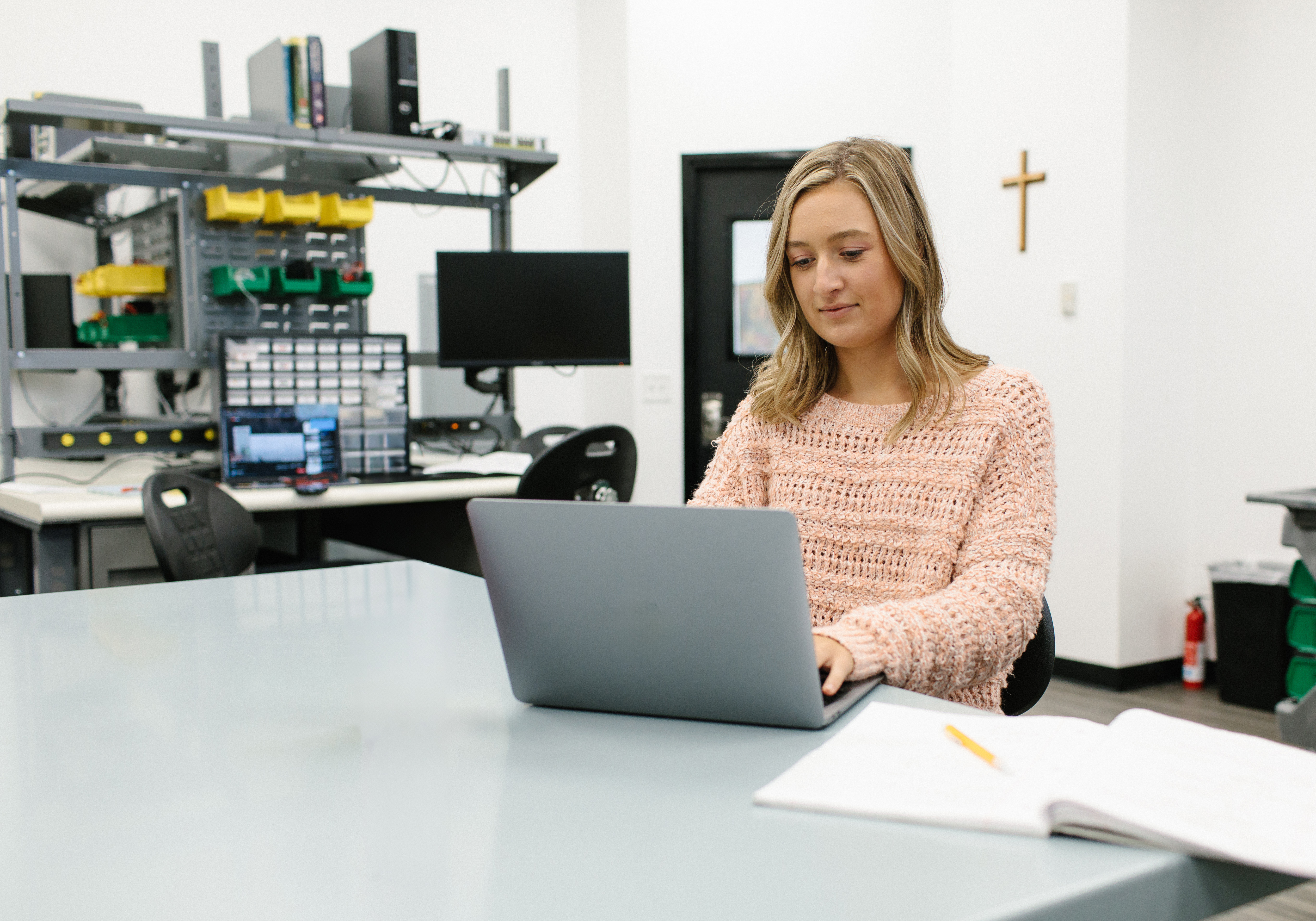 A woman sitting at a desk using a laptop