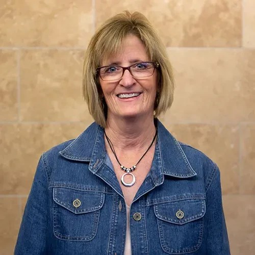 A woman wearing a denim jacket