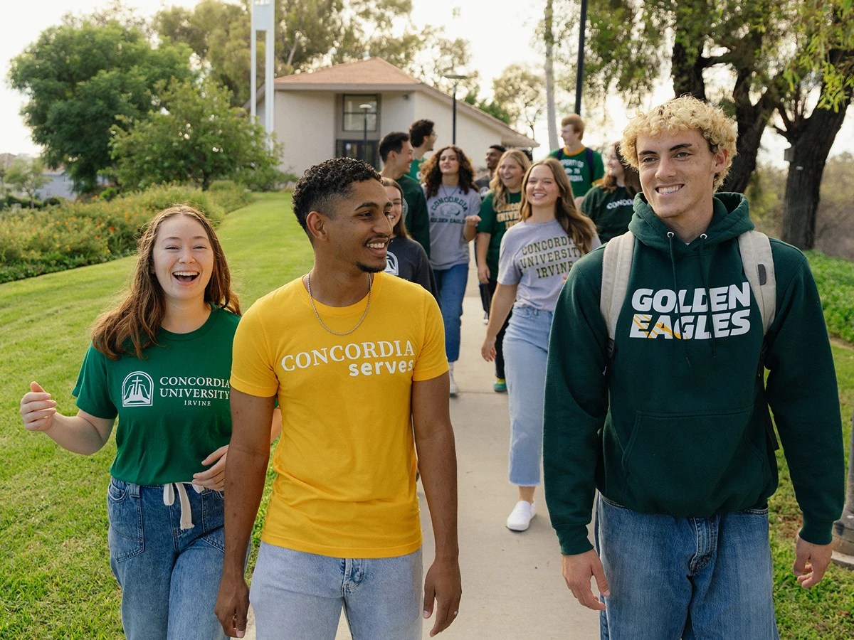 A group of people walking on a sidewalk