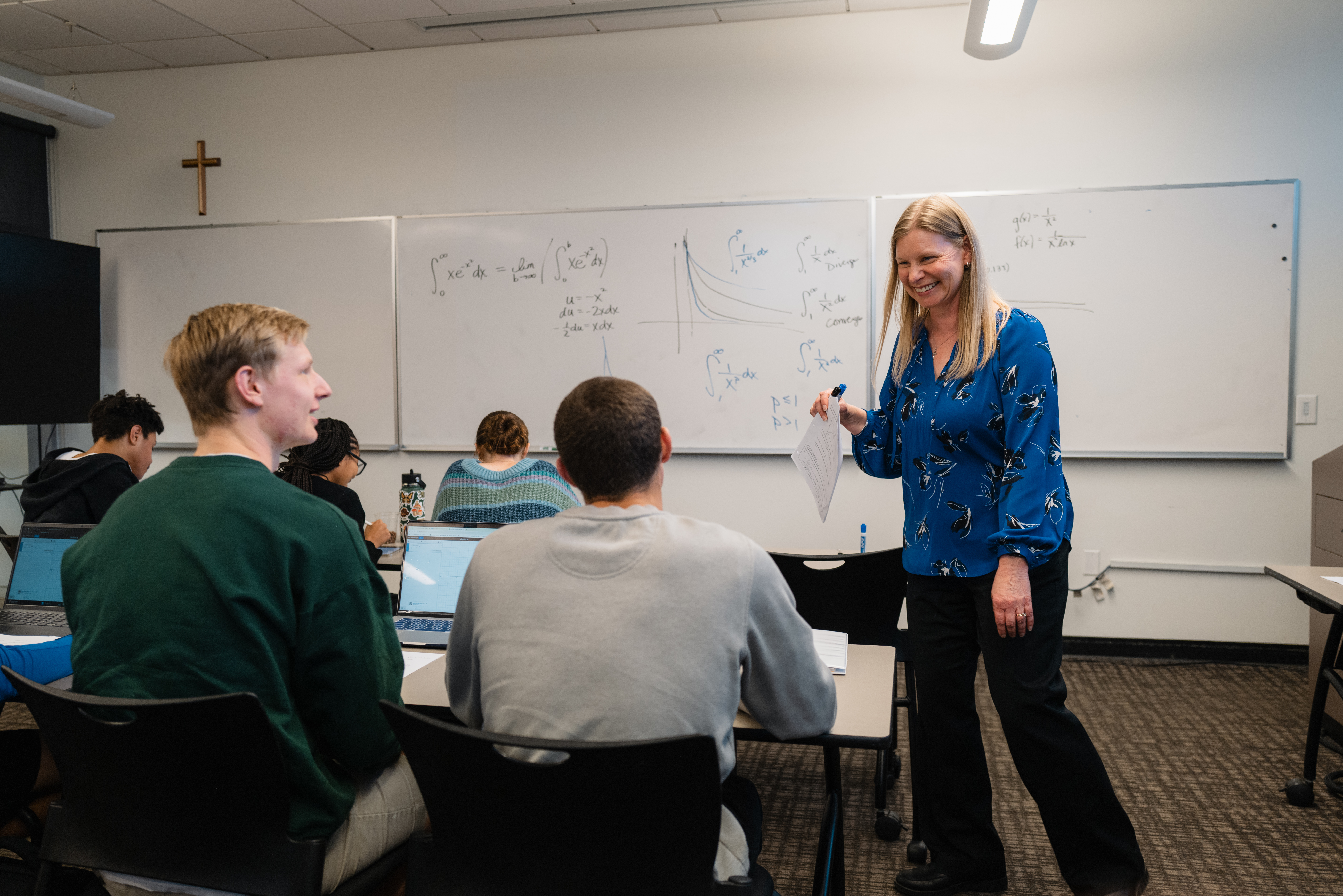 A woman standing in front of a whiteboard