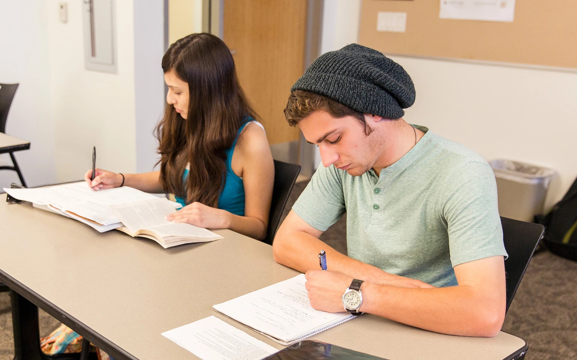 A man and woman studying at a table