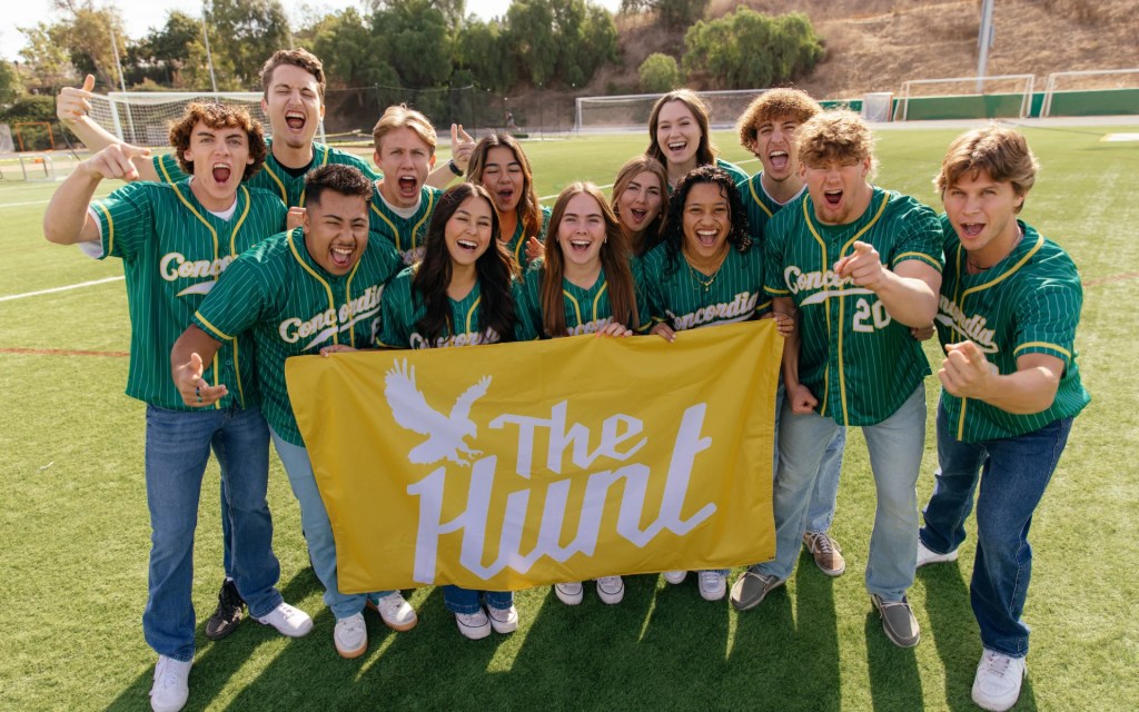 A group of people holding a banner
