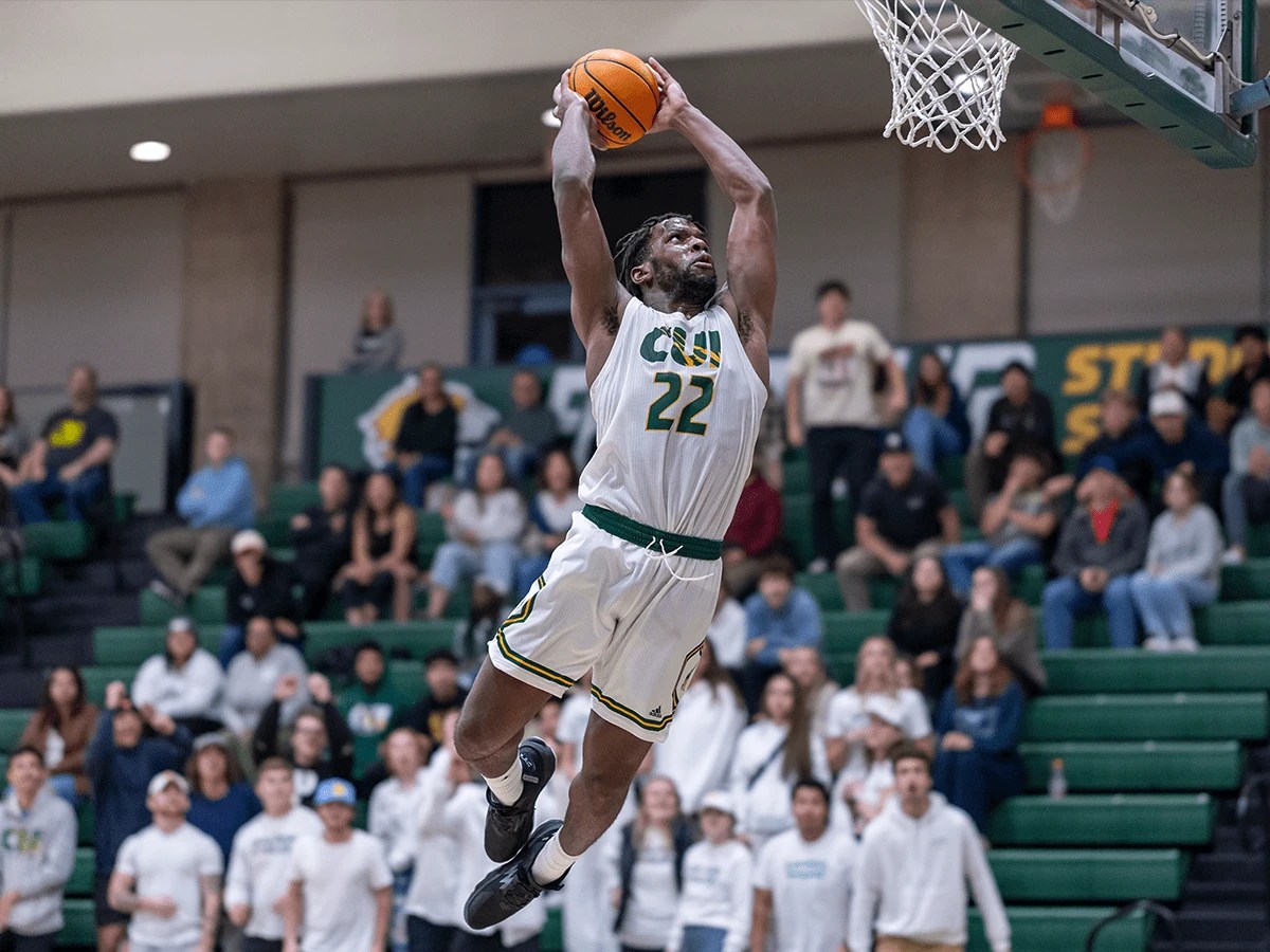 A man jumping in the air with a basketball in the air