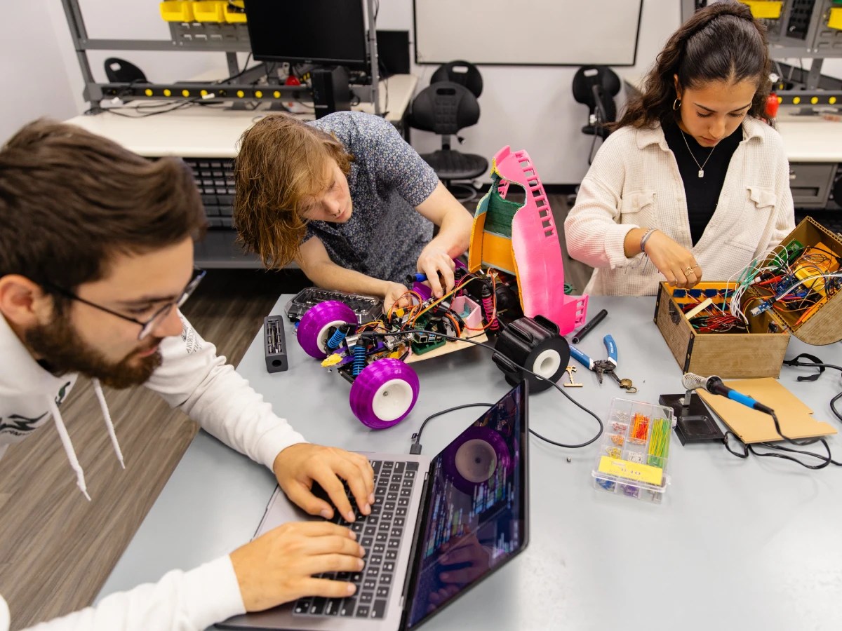 A group of people working on a robot