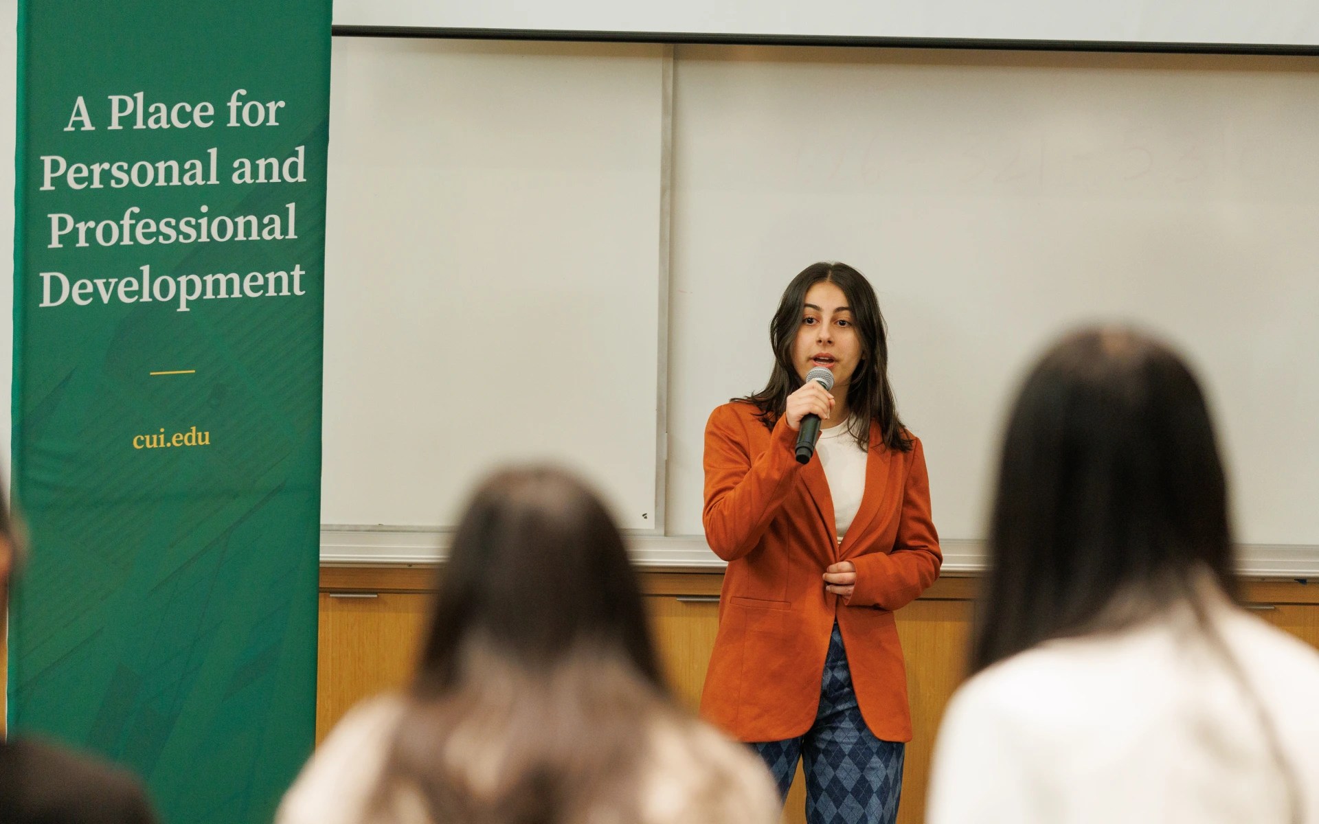 A woman speaking into a microphone